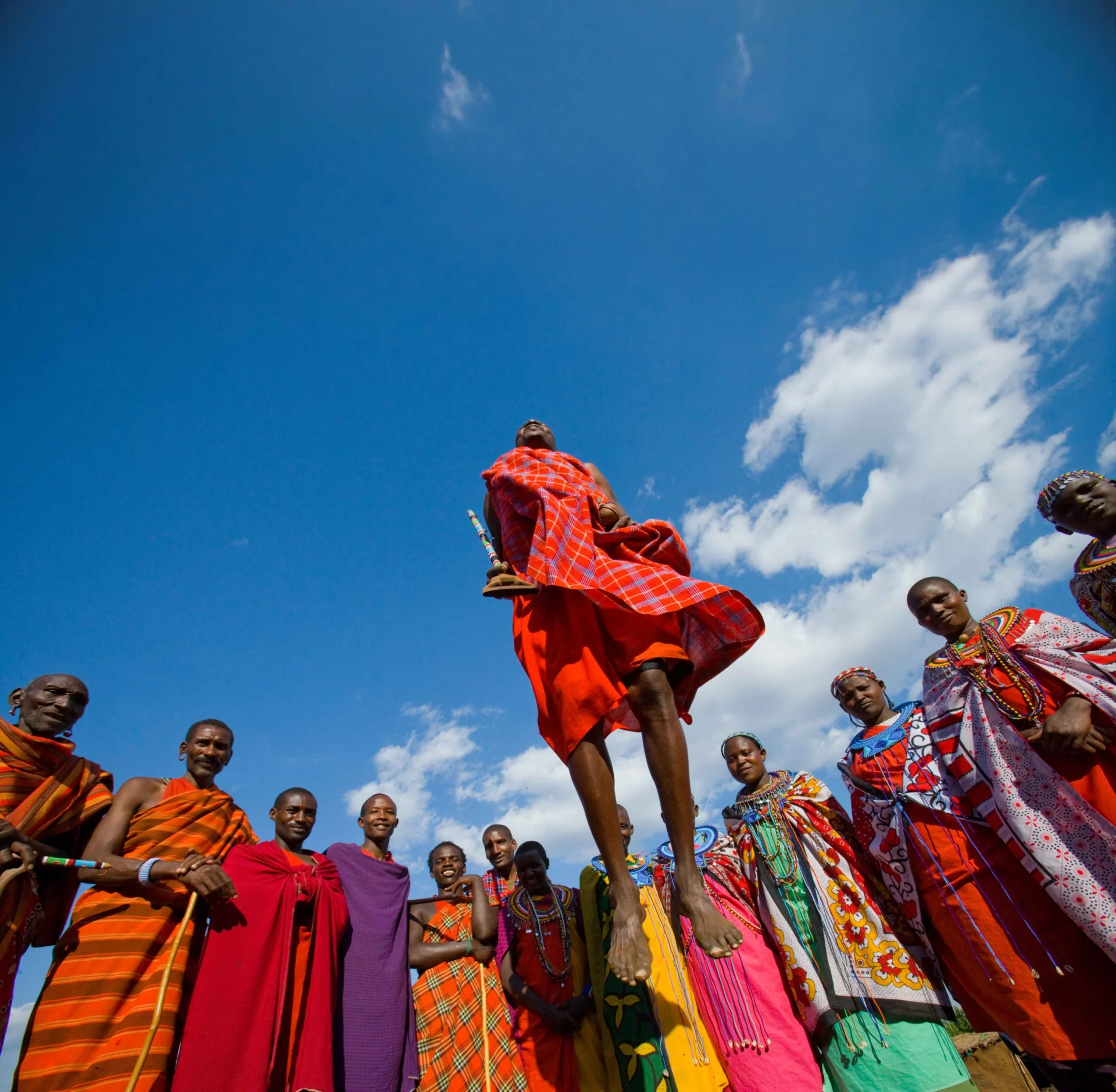 Maasai women are standing at the gates of Masai village.